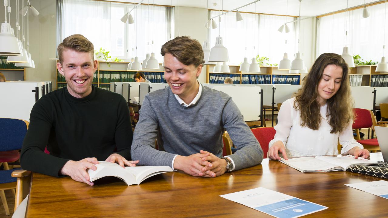 Studenter i läsesal läser böcker och studerar