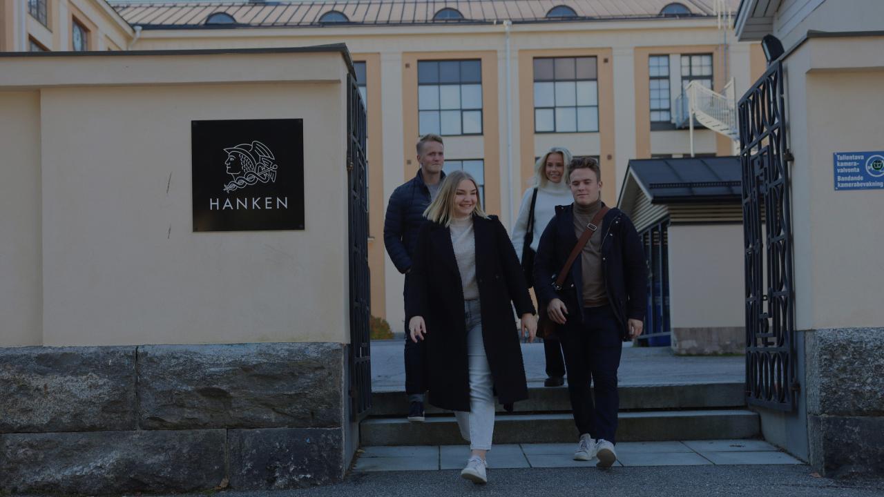Four students walking from the Hanken main building in Vaasa