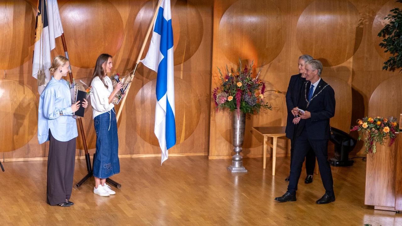 Studenter och rektor på scenen i Hankens festsal