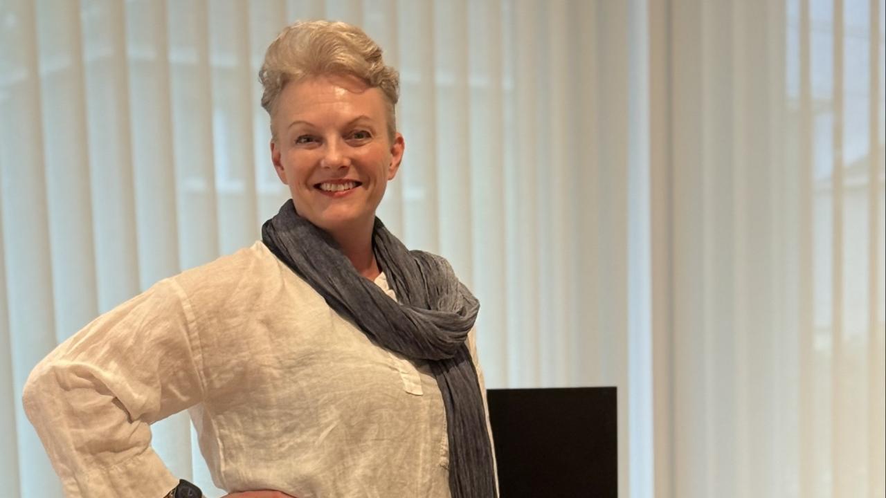 Johanna Söderström standing at a desk in an office.