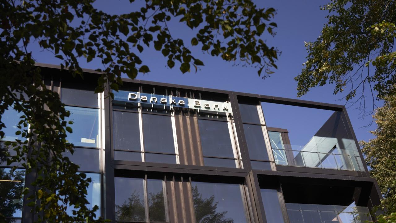 Danske Bank office pictured from outside against a blue sky.