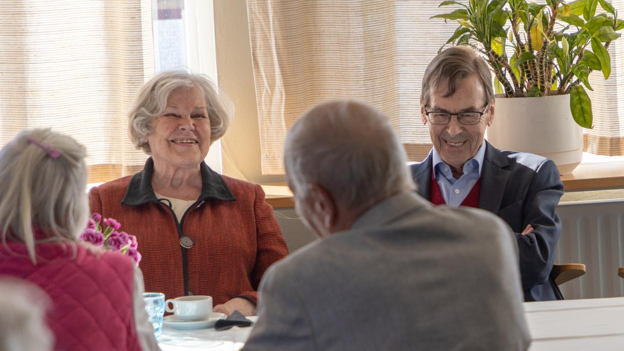 Alumni Elisabeth Rehn and Bengt Ohls sitting at a table laughing.