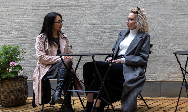 Two students sitting outside