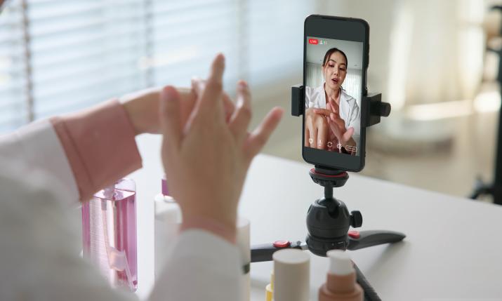 An influencers filming content while testing beauty products.