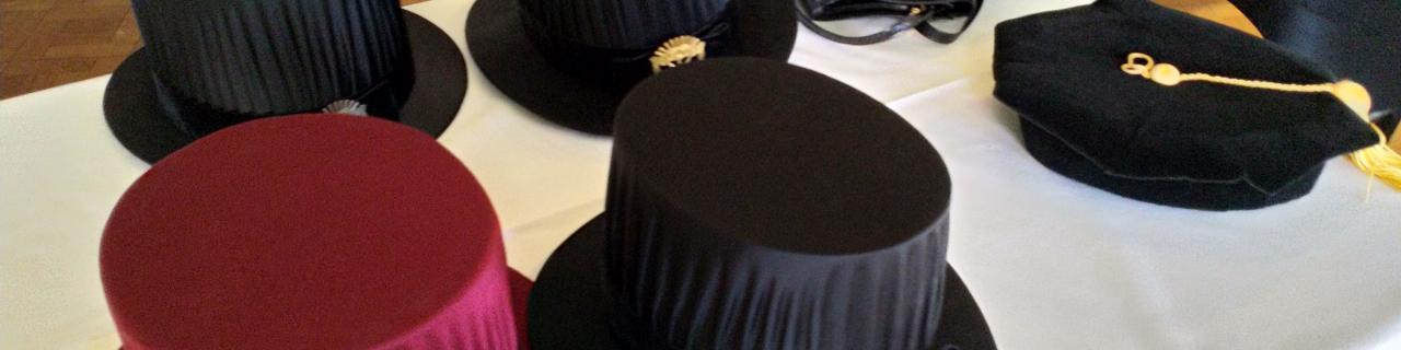 Table set with a few doctoral hats