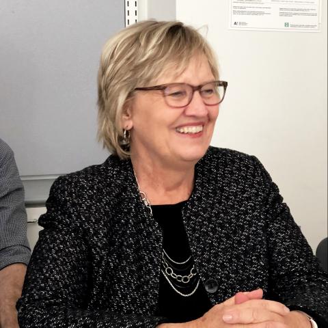 Mary Jo Bitner in a black jacket, smiling