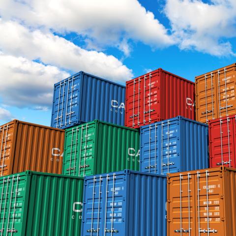 Containers stacked on top of each other against a blue sky