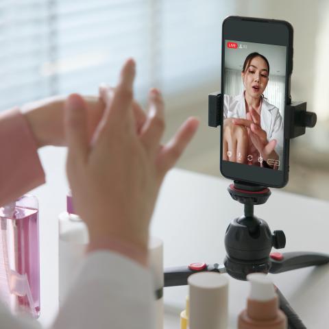 An influencers filming content while testing beauty products.