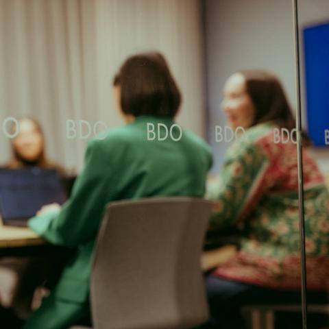 People sitting in a meeting room.