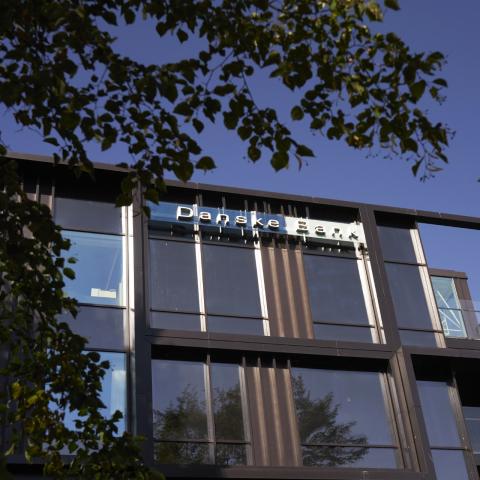 Danske Bank office pictured from outside against a blue sky.